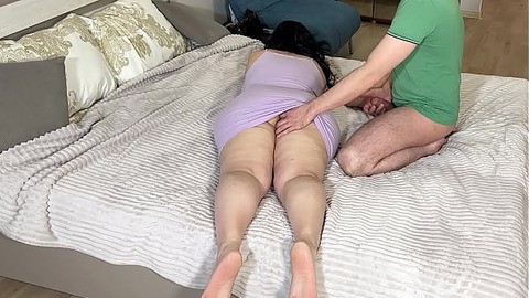 In the bedroom, the stepmom lay down on the bed and the stepson got excited